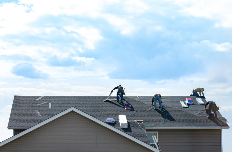 4,Construction,Workers,Fixing,Roof,Against,Clouds,Blue,Sky