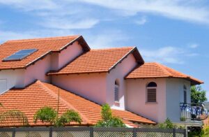 How to Get an Instant Roof Quote 1 Orange tile roof installed on a two-story brick home