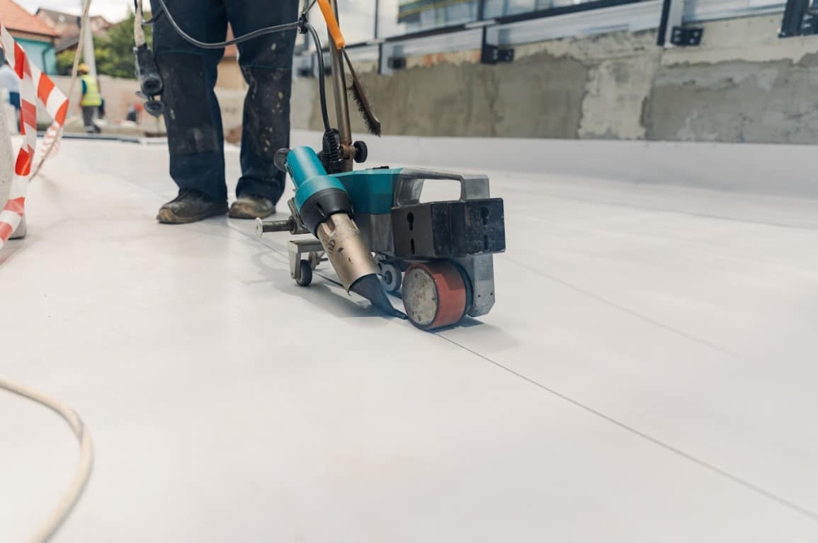 Contractor applying TPO on a commercial roof in Florida