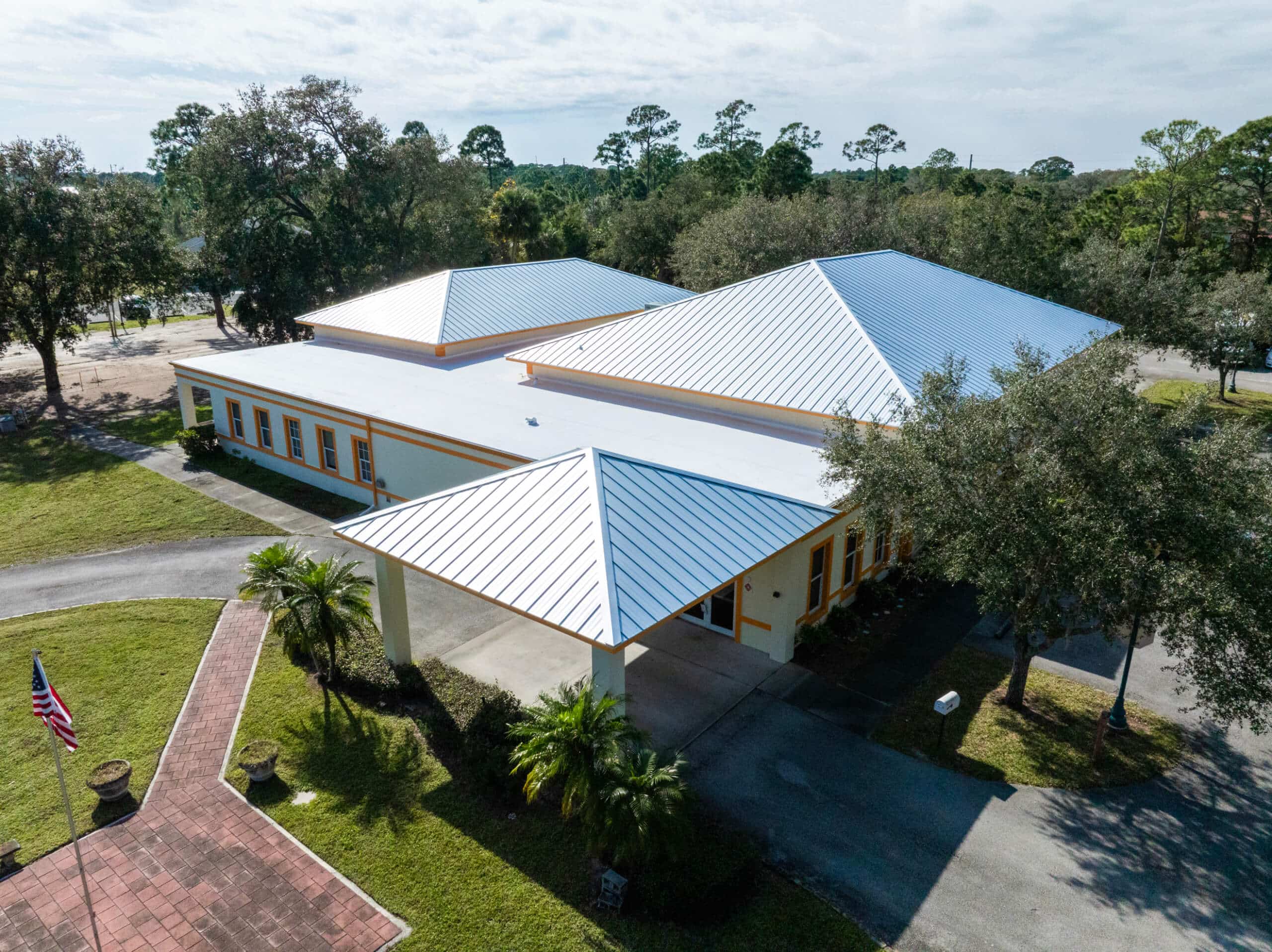 Aerial view of completed metal roof replacements on waterfront homes in Florida