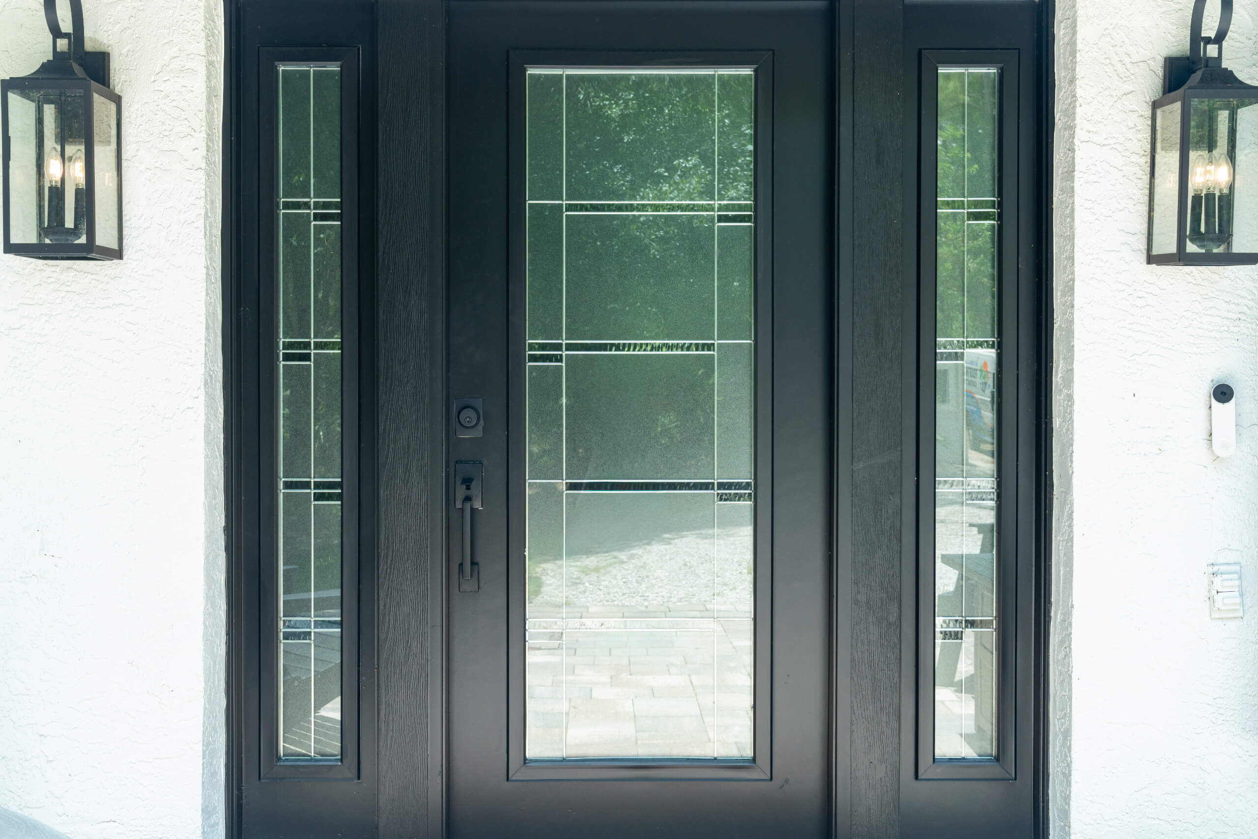 Black modern front entry door with glass panels installed by My Florida Roofing Contractor
