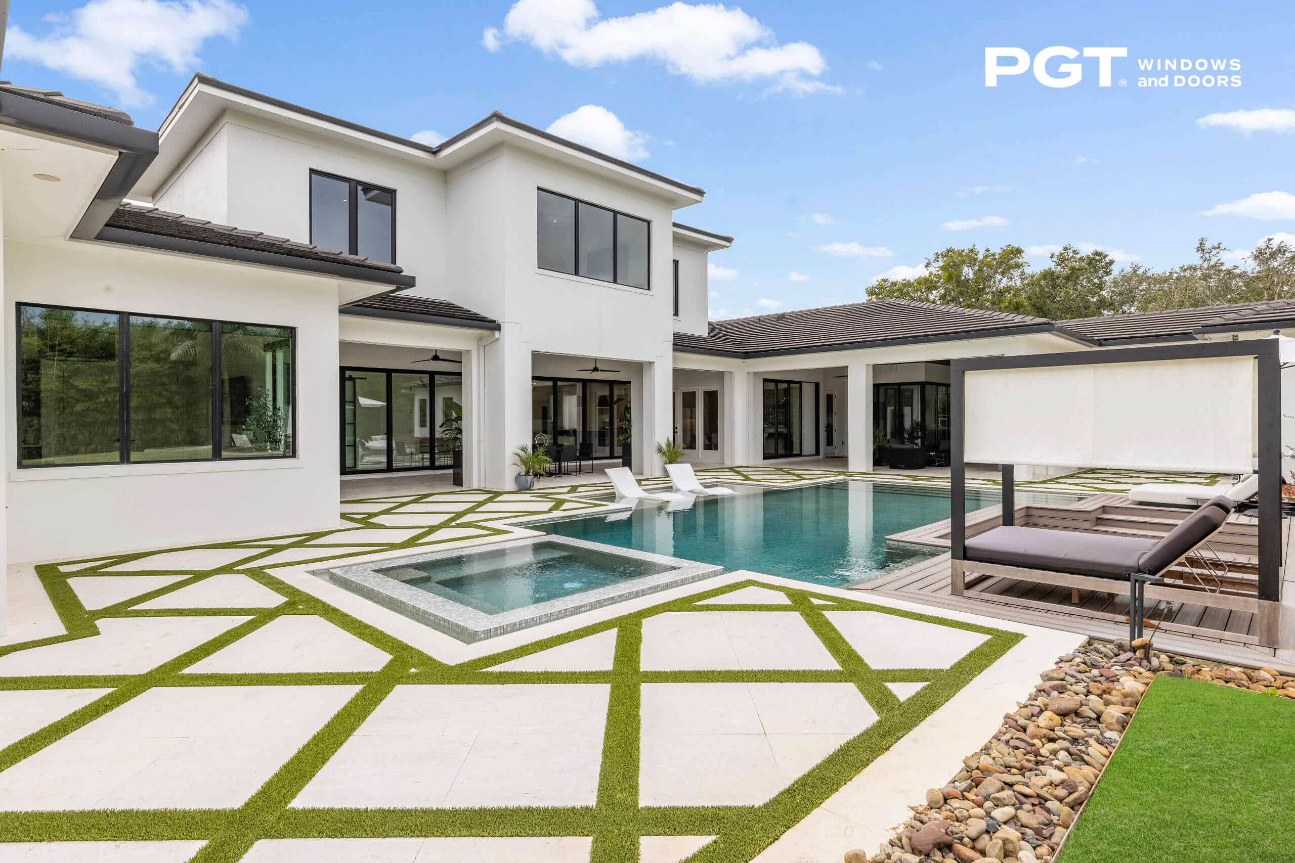 PGT impact windows and sliding glass doors installed around a modern home with a backyard pool