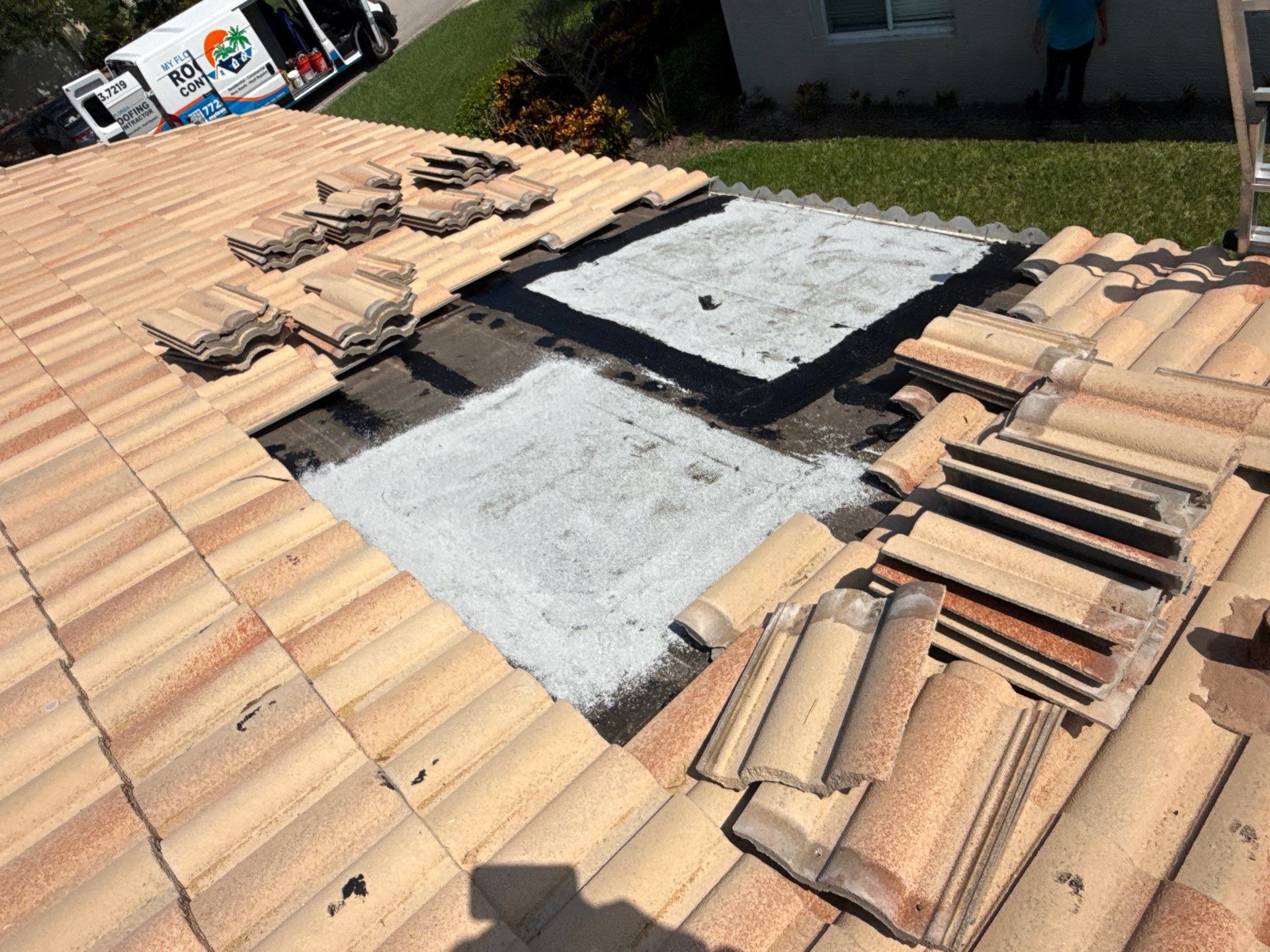 rooftop view of a tile roof repair on a florida home
