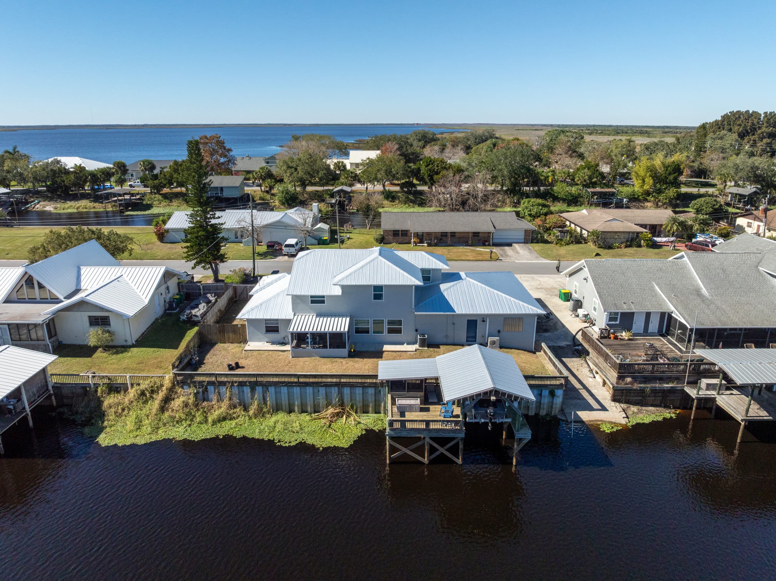 ariel image of a inter coastal home with a new white metal roof facing the waterfront