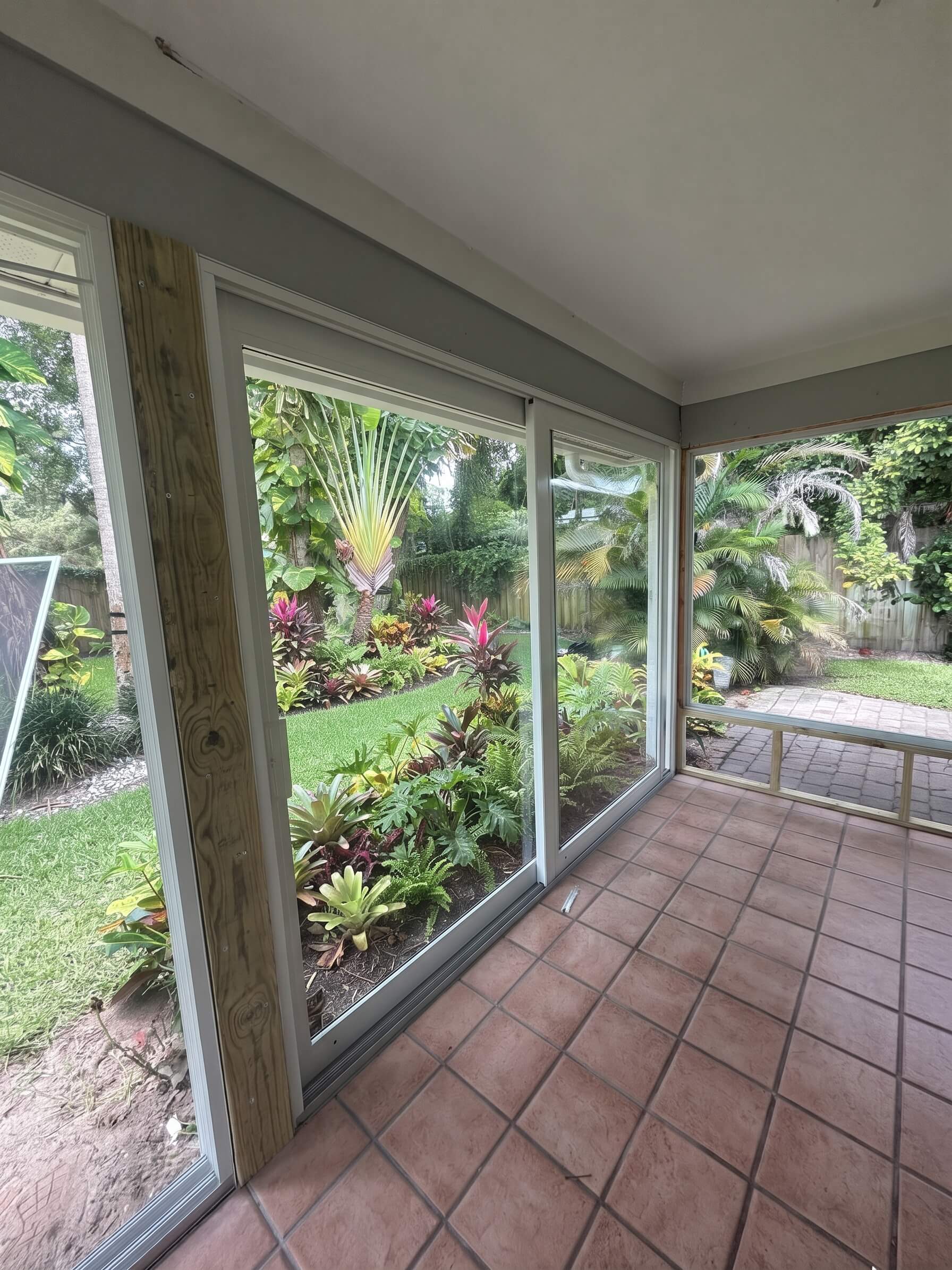 Sliding glass door replacement overlooking a landscaped backyard in Vero Beach, Florida