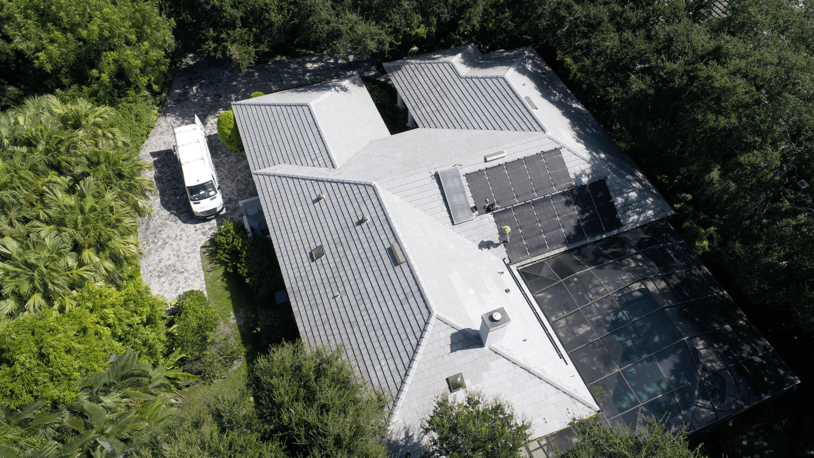 Aerial view of a tile roof replacement with solar panels on a home in Vero Beach, Florida