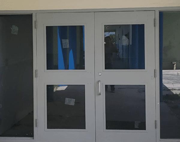 Impact-rated double entry doors with glass panels installed on a commercial building