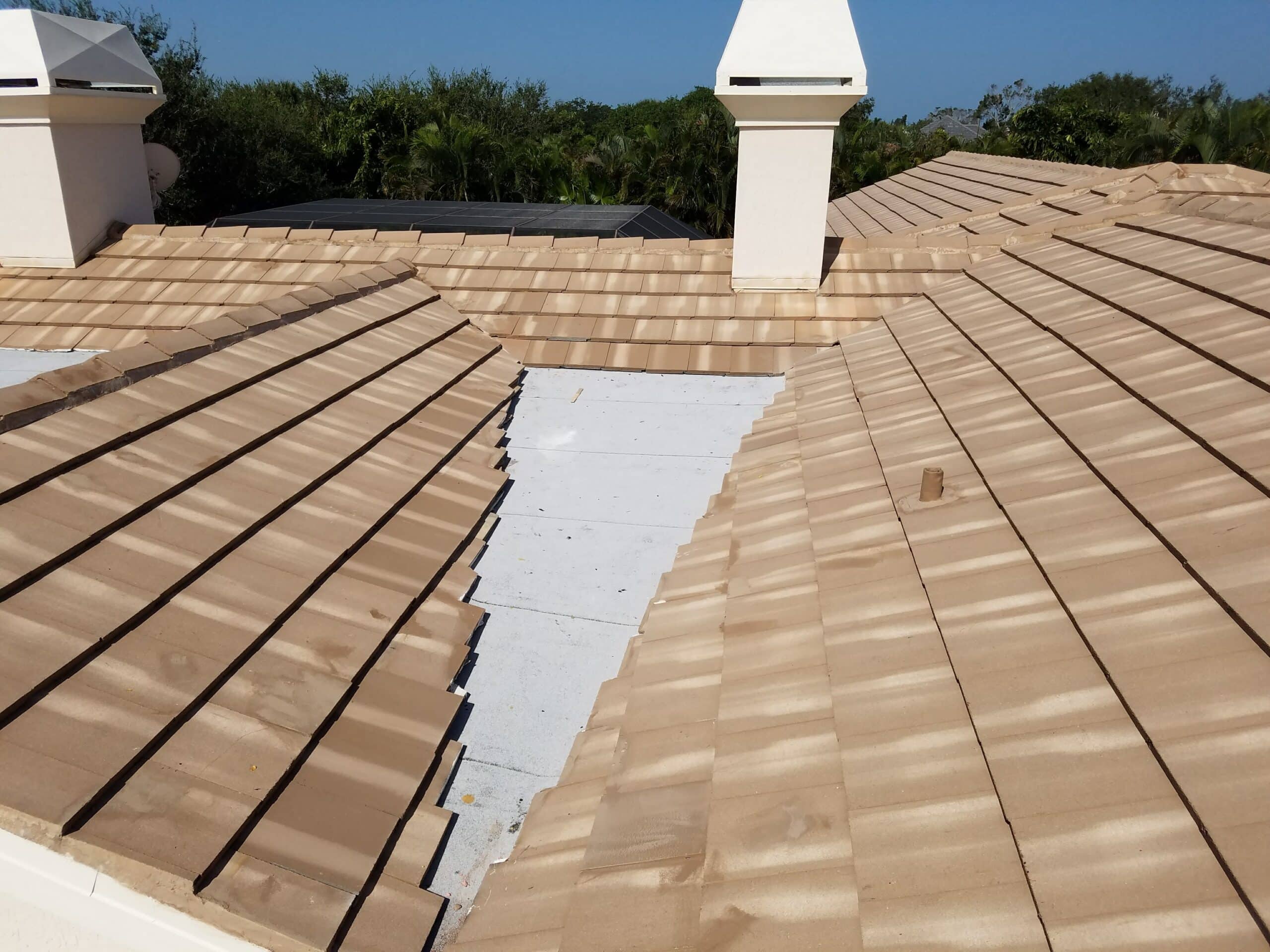 rooftop view of a tile roof repair on a florida home