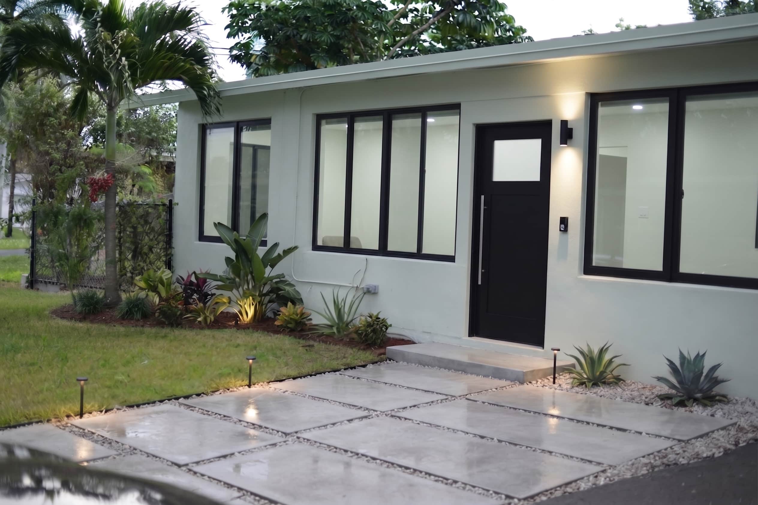replacement windows with a black frame on a single story family home