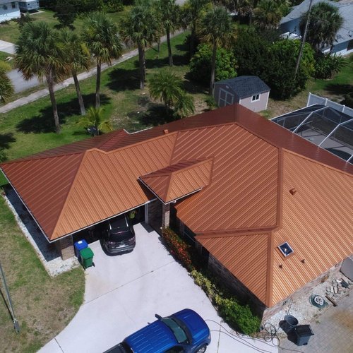 Aerial view of a terracotta Kynar-coated metal roof, complete guide to metal roofing Kynar coated systems in Florida by My Florida Roofing Contractor